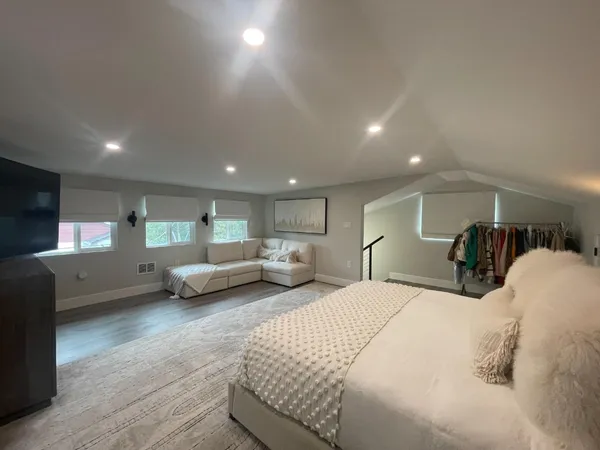 a bedroom with a bed window and a couch