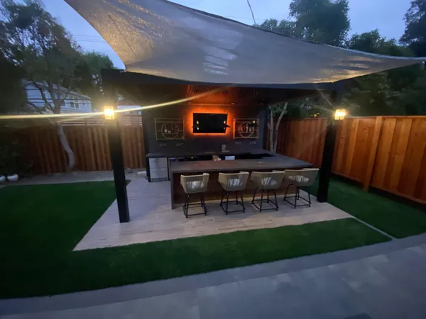 a kitchen with a sink cabinets and wooden floor
