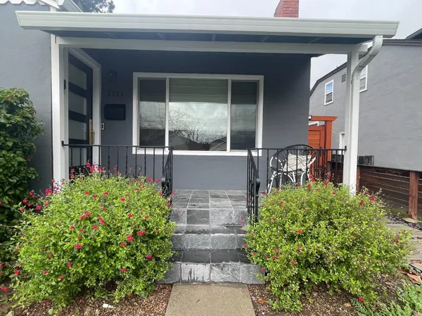 a front view of a house with garden