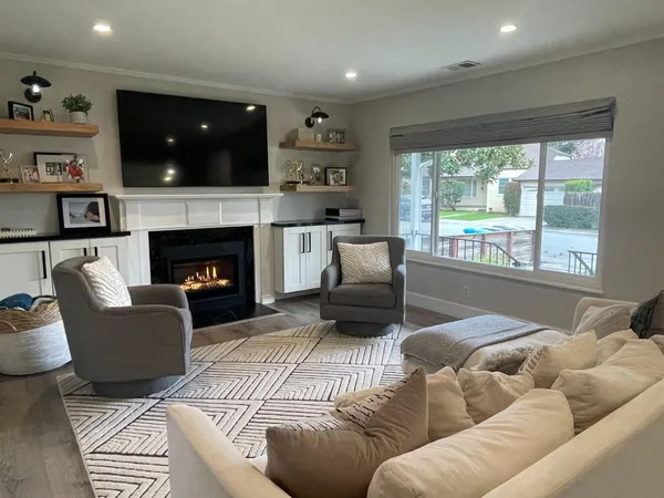 a living room with furniture and a fireplace