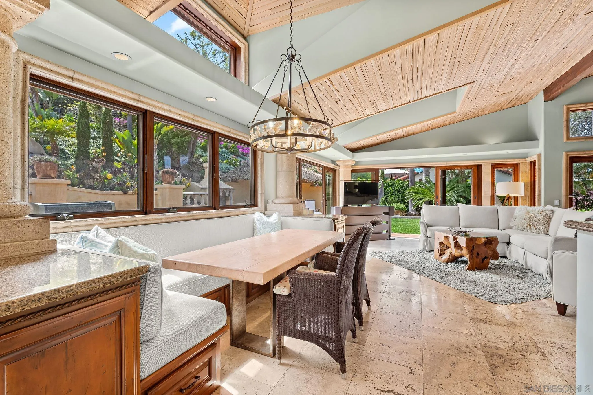 2969 Racetrack View Drive Del Mar, CA 92014 - Photo 17 of 59 a dining room with wooden floor a chandelier a wooden table and chairs