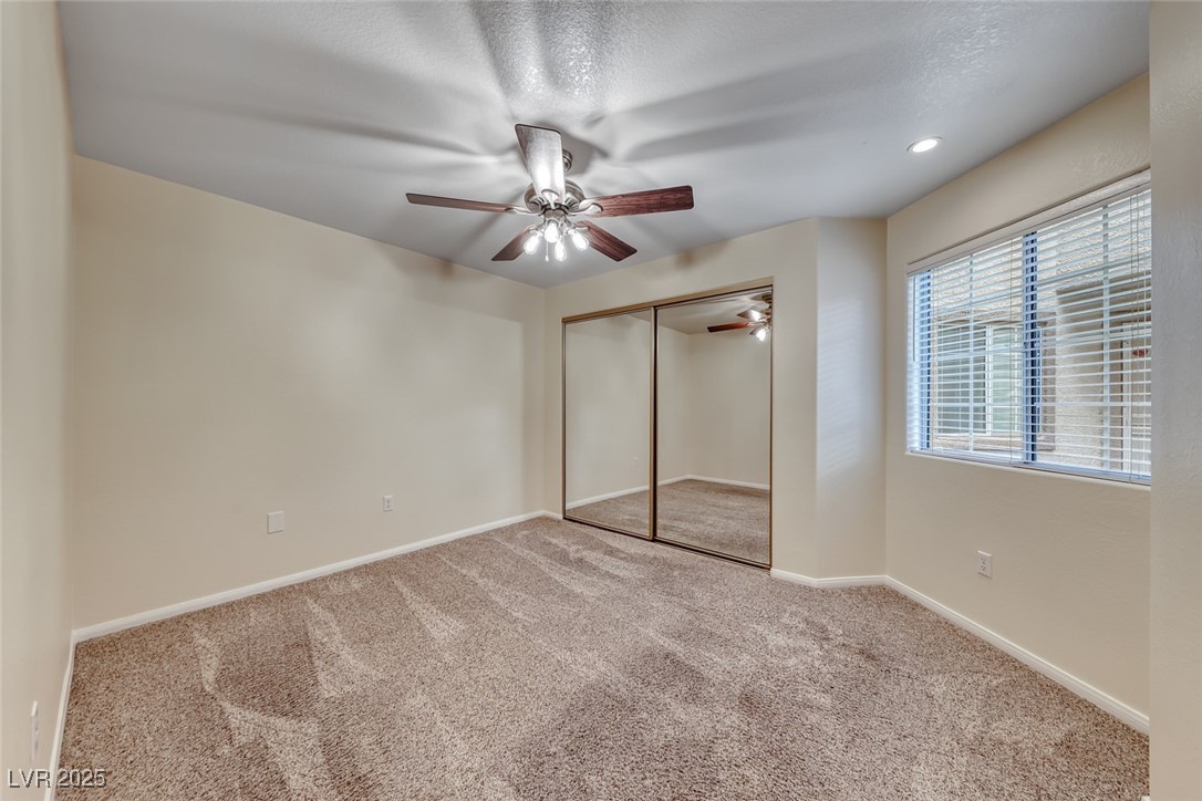 1851 Hillpointe Road, Unit 1811 Henderson, NV 89074 - Photo 26 of 49 2nd bedroom with ceiling fan/light and carpet.