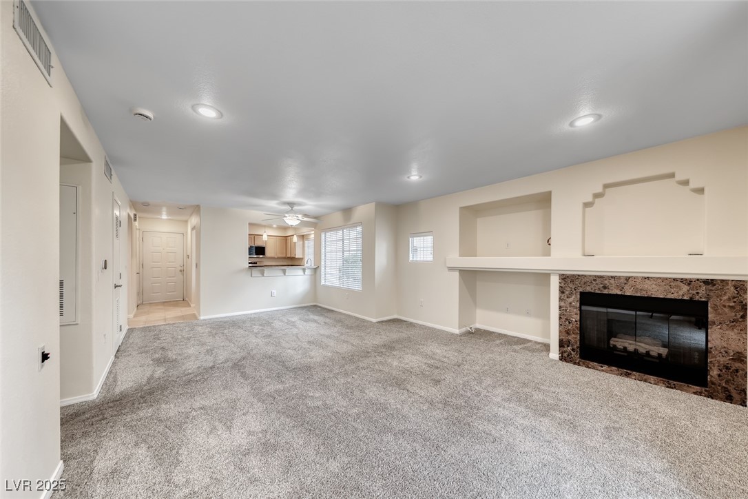 1851 Hillpointe Road, Unit 1811 Henderson, NV 89074 - Photo 3 of 49 Large living room with carpet, gas fireplace and recessed lighting