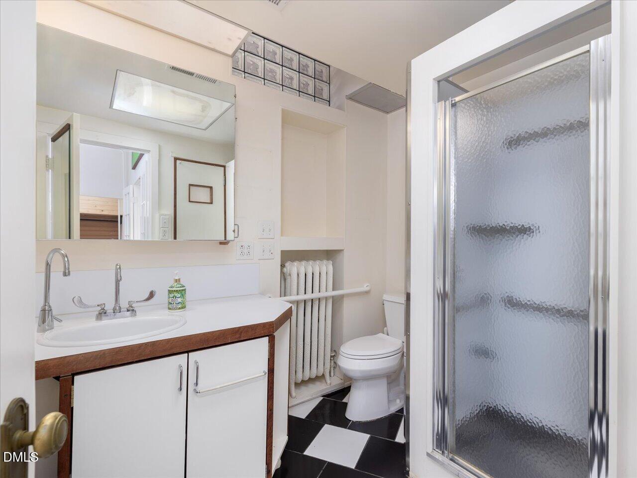 215 Hillcrest Road Raleigh, NC 27605 - Photo 57 of 97 a bathroom with a sink a toilet and shower