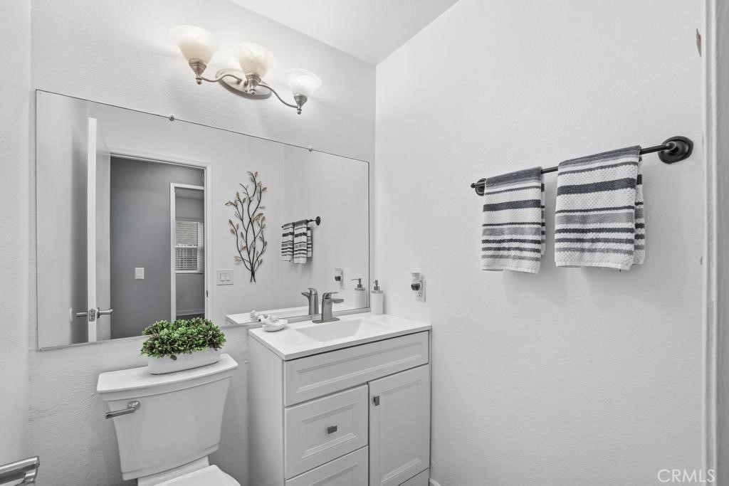 45664 Balmoral Court Lancaster, CA 93534 - Photo 12 of 38 a bathroom with a sink a toilet and mirror