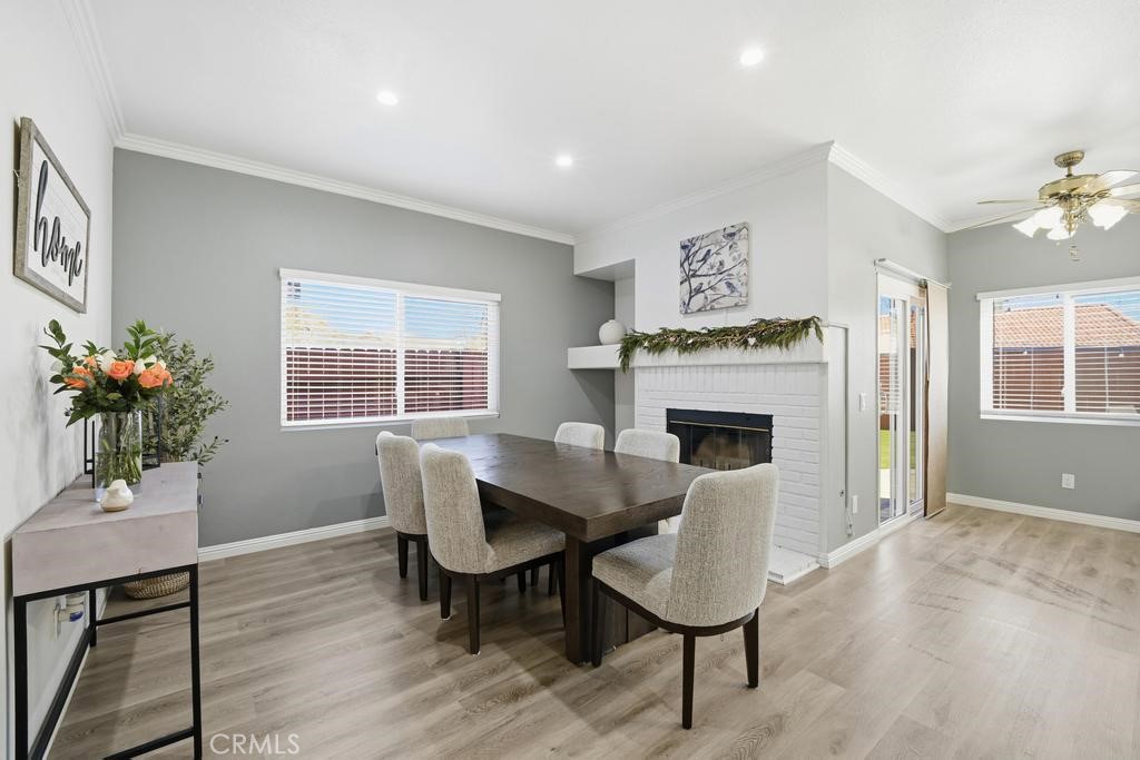 45664 Balmoral Court Lancaster, CA 93534 - Photo 13 of 38 a dining room with furniture potted plants and wooden floor