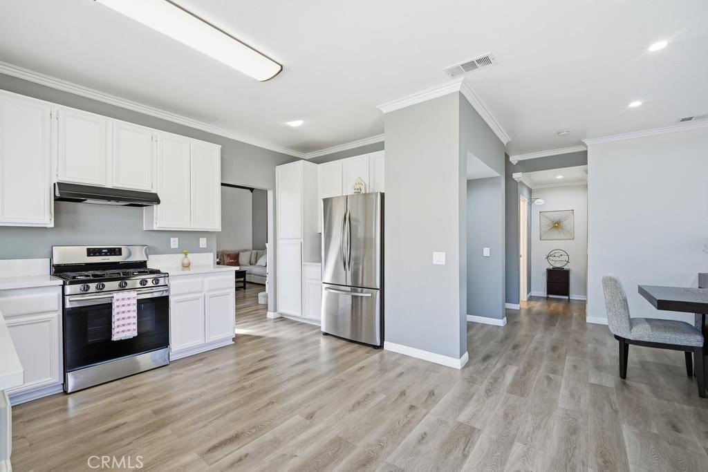 45664 Balmoral Court Lancaster, CA 93534 - Photo 18 of 38 a kitchen with stainless steel appliances granite countertop a stove and a refrigerator