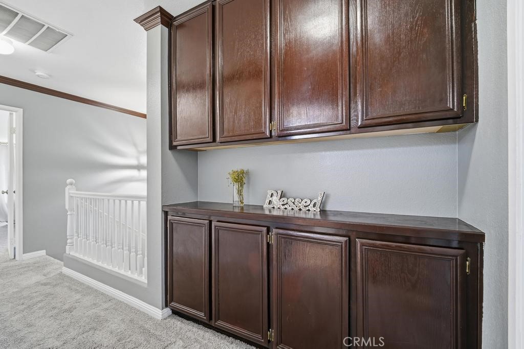 45664 Balmoral Court Lancaster, CA 93534 - Photo 21 of 38 a kitchen with stainless steel appliances granite countertop white cabinets and a refrigerator