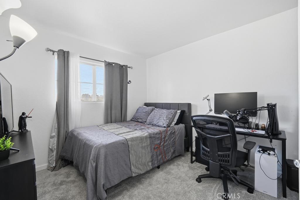 45664 Balmoral Court Lancaster, CA 93534 - Photo 29 of 38 a bedroom with a bed and a desk
