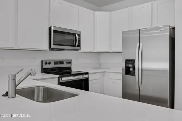 a kitchen with a sink and a refrigerator