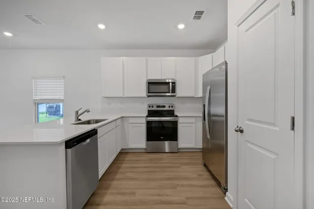 a kitchen with a refrigerator and a sink