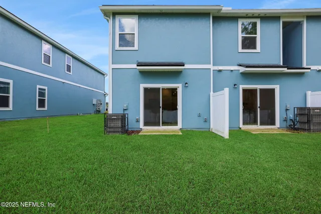 a view of an house with backyard space and a garden