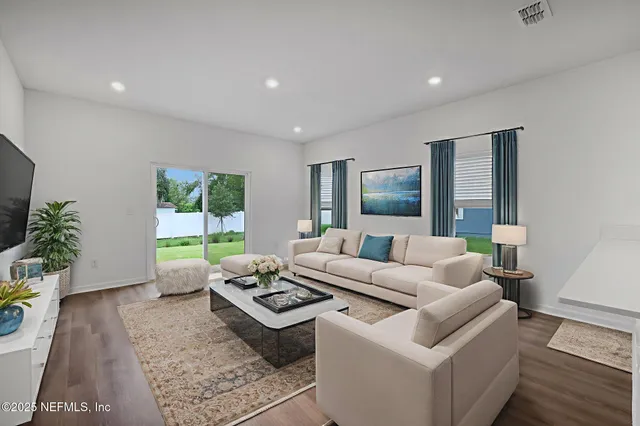 a living room with furniture and a large window