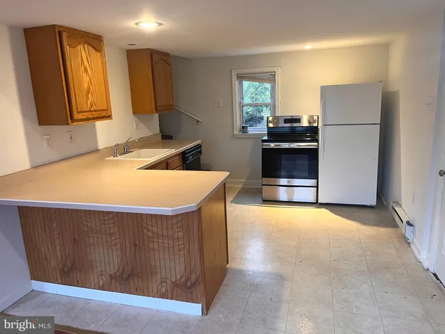 a kitchen with a appliances and a refrigerator
