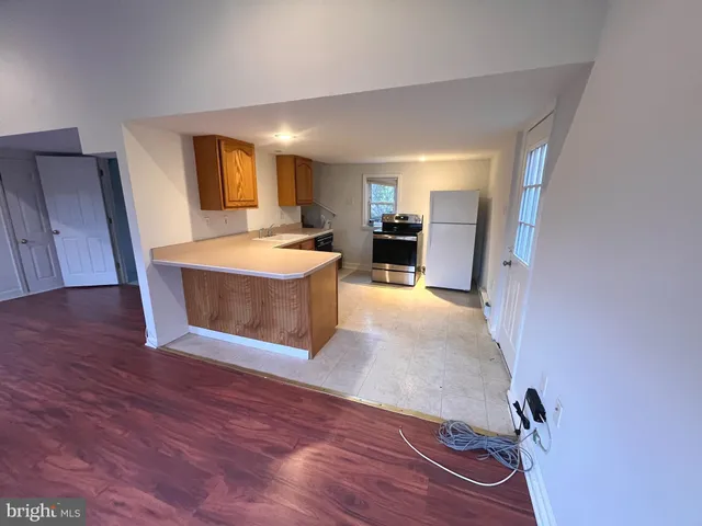a view of kitchen with furniture and wooden floor