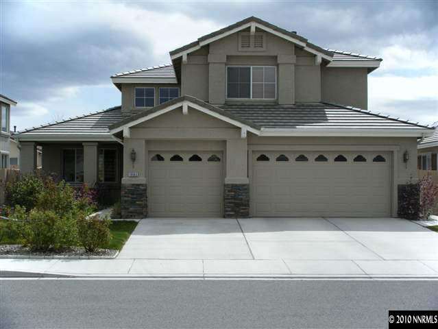 10063 Kentfield Place Reno, NV 89521 - Photo 1 of 1 a front view of a house with a garage