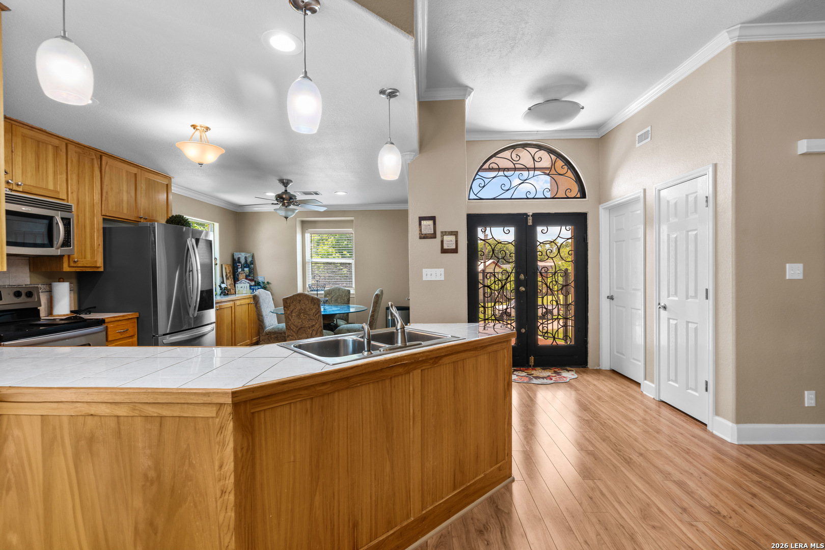 3900 Apache Circle Kingsland, TX 78639 - Photo 15 of 36 a view of a kitchen with granite countertop a sink stainless steel appliances and cabinets