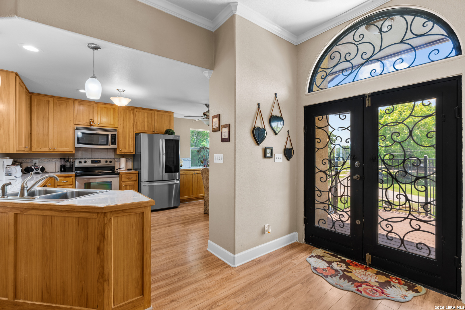 3900 Apache Circle Kingsland, TX 78639 - Photo 16 of 36 a kitchen with stainless steel appliances granite countertop a refrigerator a sink dishwasher a stove and a dining table with wooden floor