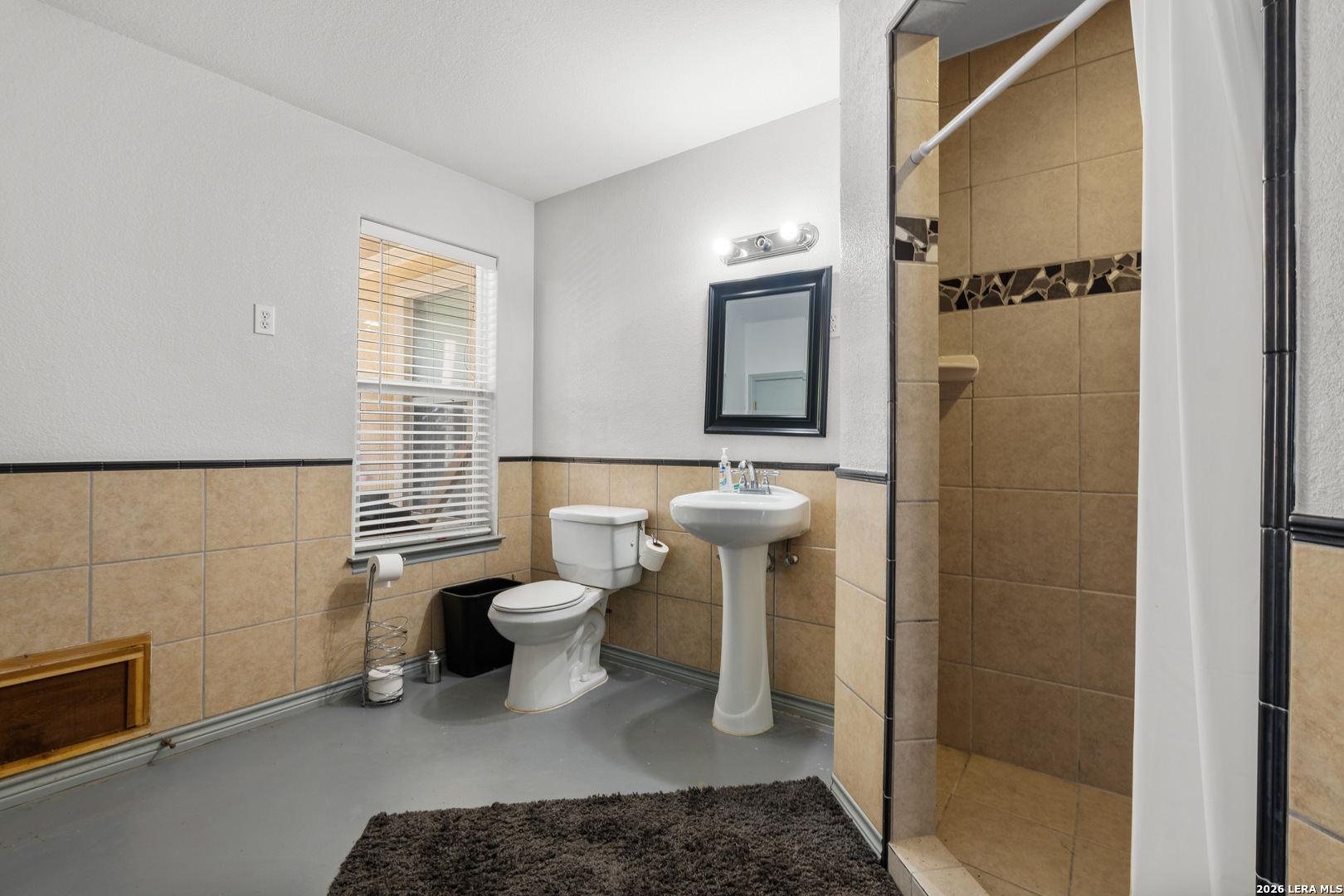 3900 Apache Circle Kingsland, TX 78639 - Photo 34 of 36 a bathroom with a toilet a sink and shower