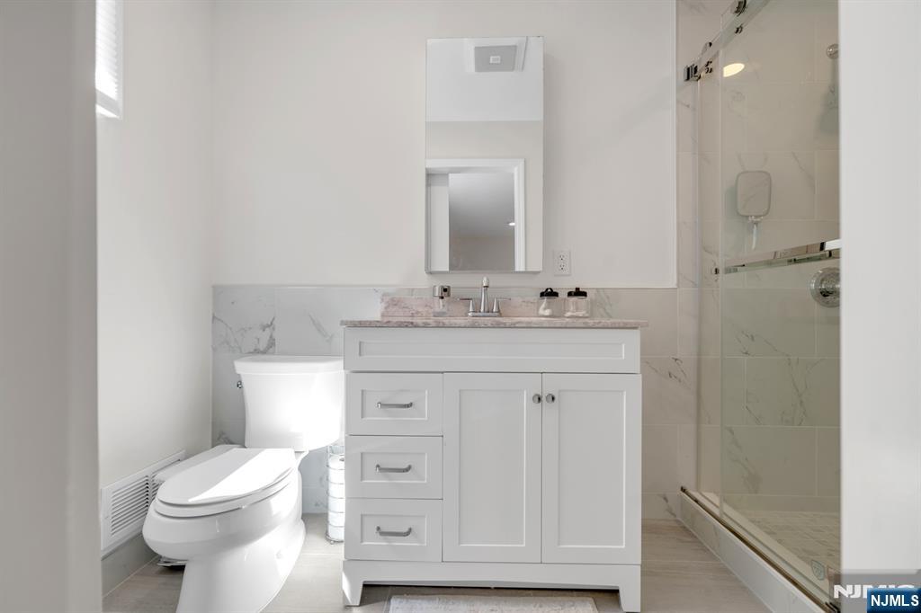 433 Piermont Road Cresskill, NJ 07626 - Photo 19 of 49 a bathroom with a toilet sink vanity and granite