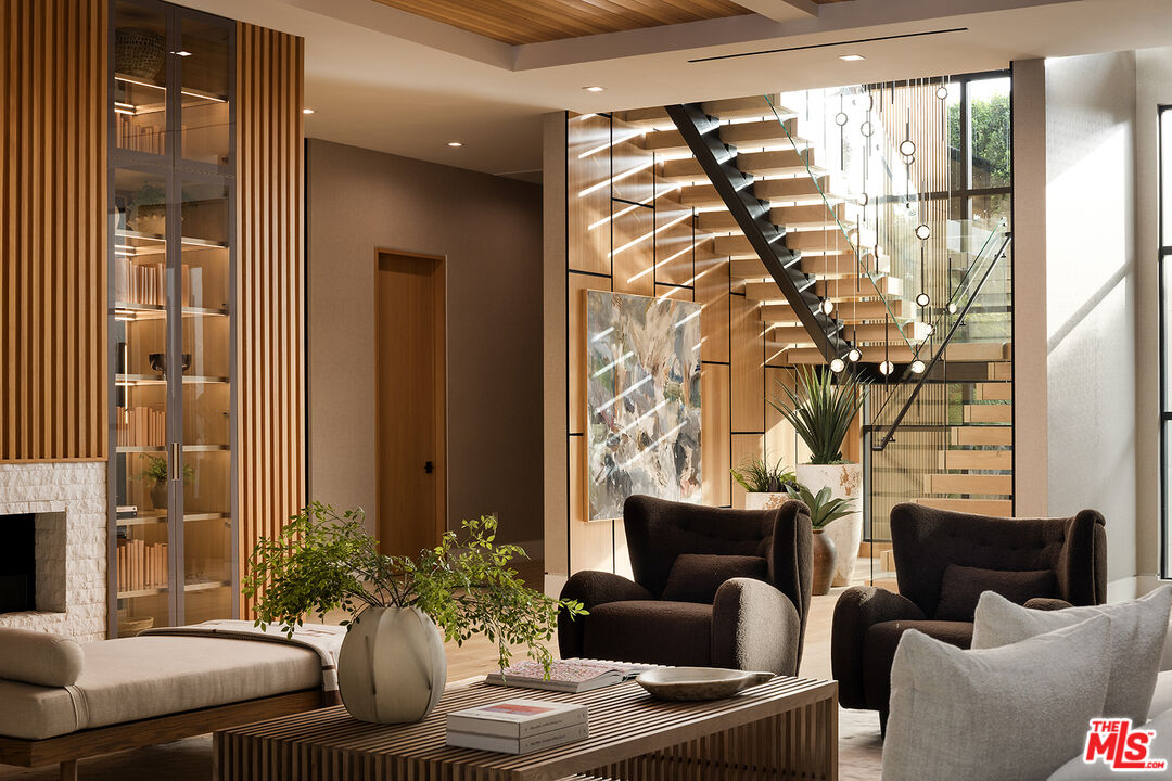 13187 Chalon Road Los Angeles, CA 90049 - Photo 14 of 39 a living room with furniture a fireplace and a potted plant