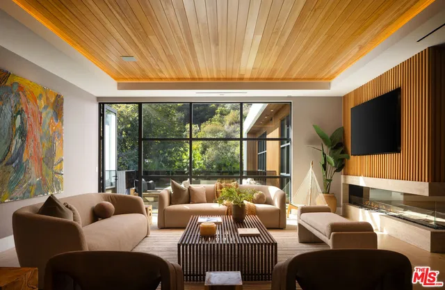 a spacious bedroom with a bed a couch and dresser