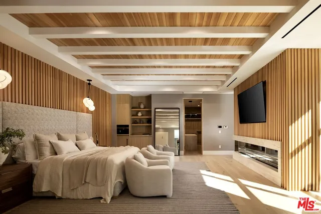 a roof deck with couches and wooden floor