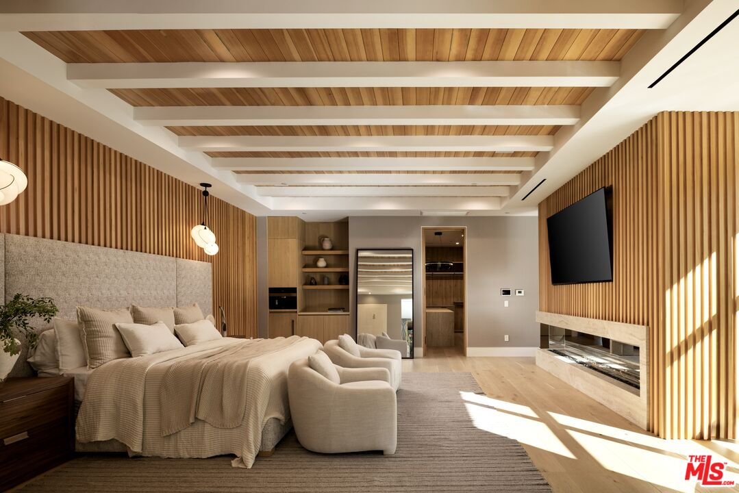 13187 Chalon Road Los Angeles, CA 90049 - Photo 17 of 39 a spacious bedroom with a bed a couch and dresser