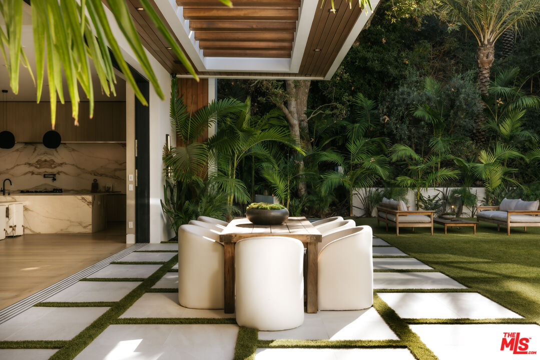 13187 Chalon Road Los Angeles, CA 90049 - Photo 2 of 39 a view of a patio with table and chairs and potted plants