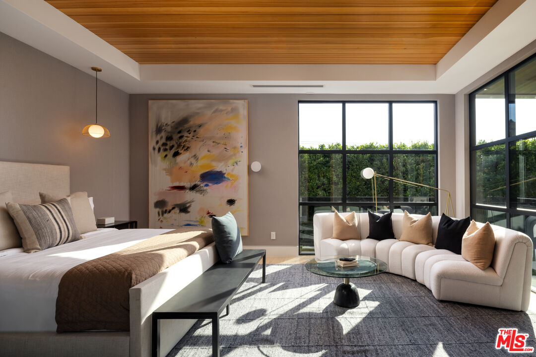 13187 Chalon Road Los Angeles, CA 90049 - Photo 21 of 39 a bedroom with furniture and a large window