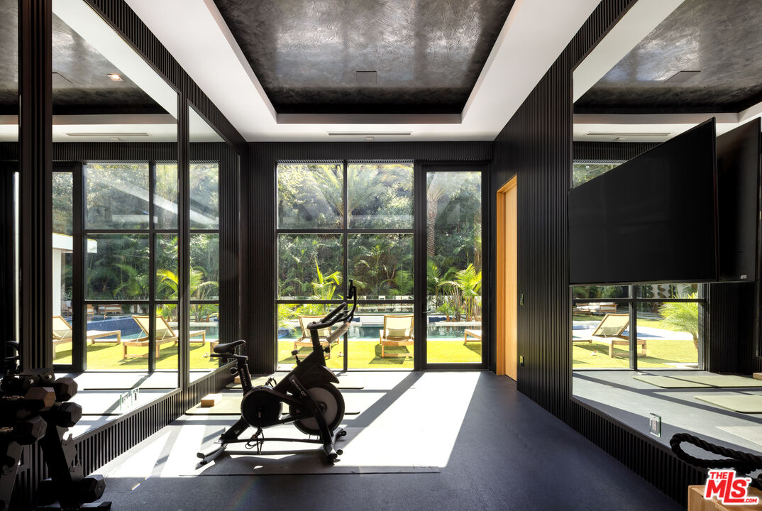 13187 Chalon Road Los Angeles, CA 90049 - Photo 29 of 39 a view of a room with wooden floor and windows