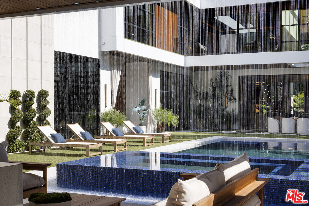 13187 Chalon Road Los Angeles, CA 90049 - Photo 3 of 39 a view of swimming pool with outdoor seating and plants