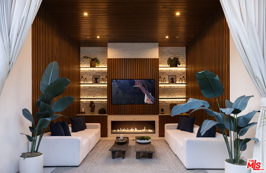 13187 Chalon Road Los Angeles, CA 90049 - Photo 36 of 39 a living room with furniture and a fireplace