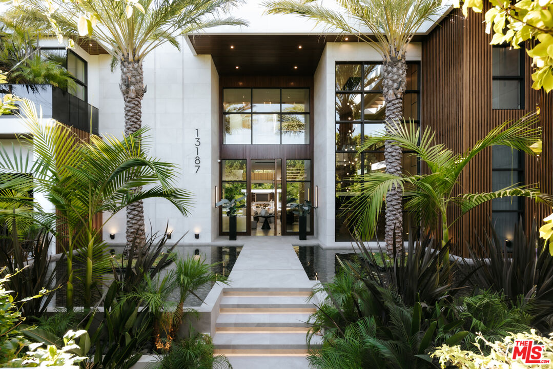 13187 Chalon Road Los Angeles, CA 90049 - Photo 5 of 39 a house with potted plants in front of it