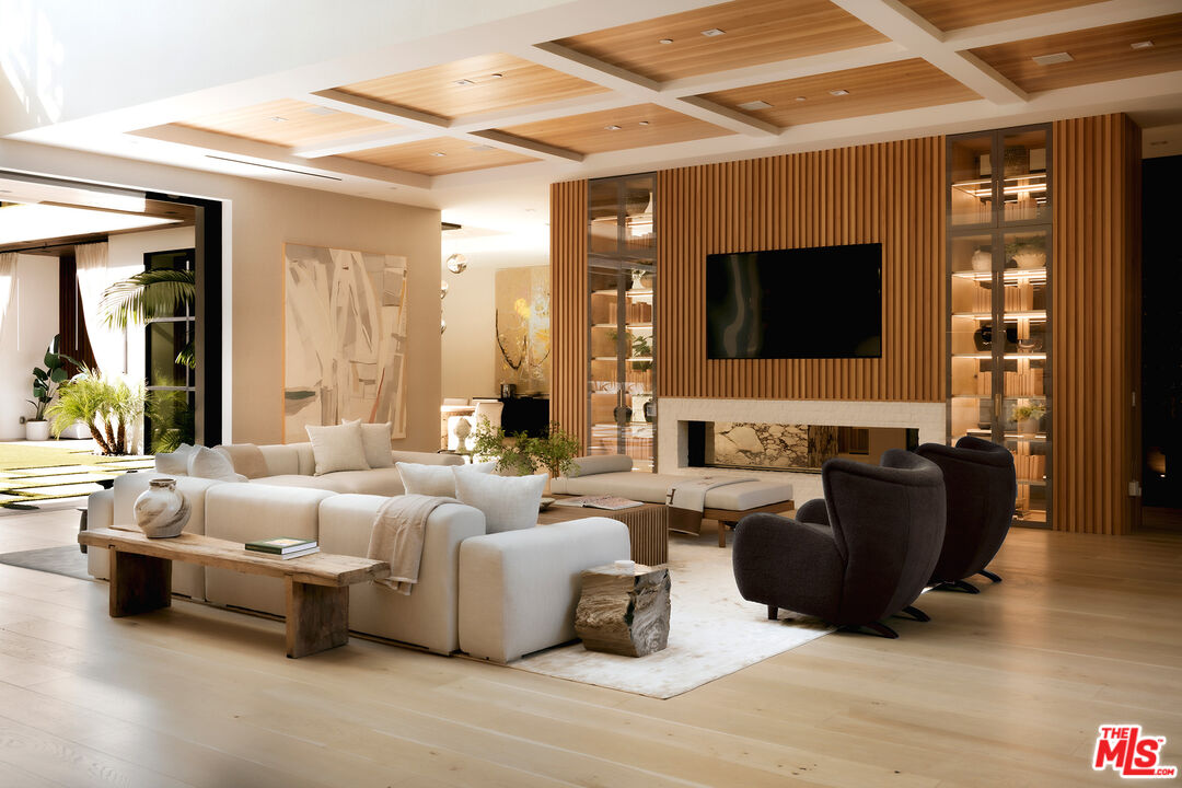 13187 Chalon Road Los Angeles, CA 90049 - Photo 6 of 39 a living room with furniture a flat screen tv and a large window