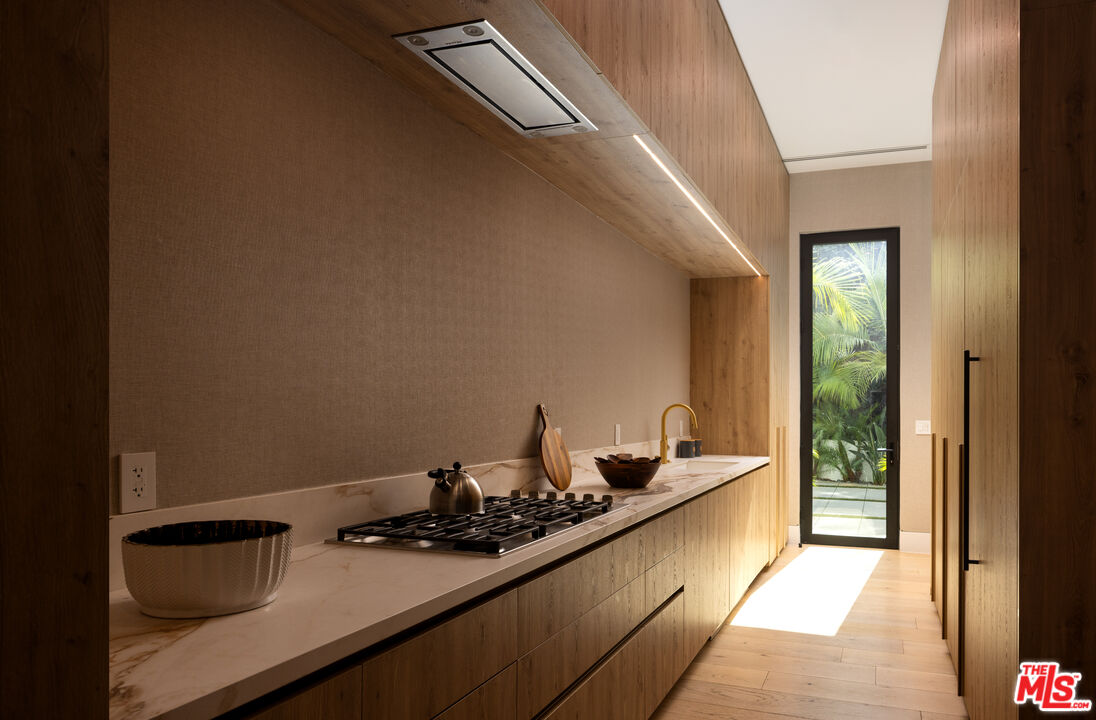 13187 Chalon Road Los Angeles, CA 90049 - Photo 9 of 39 a kitchen with a sink and cabinets