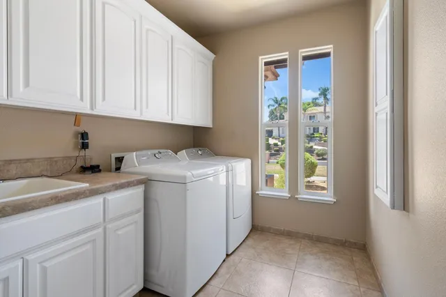 a bathroom with a granite countertop bathtub a sink and a large mirror