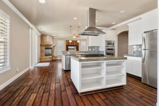 a kitchen with stainless steel appliances granite countertop a stove and a sink