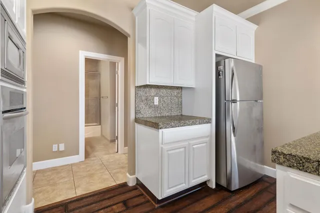 a kitchen with granite countertop lots of counter top space and stainless steel appliances