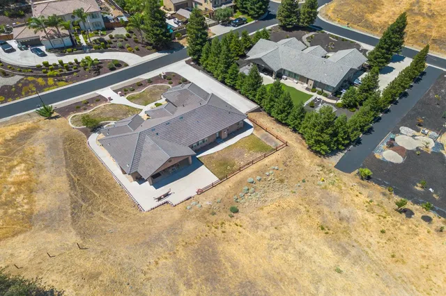 an aerial view of a house with a swimming pool