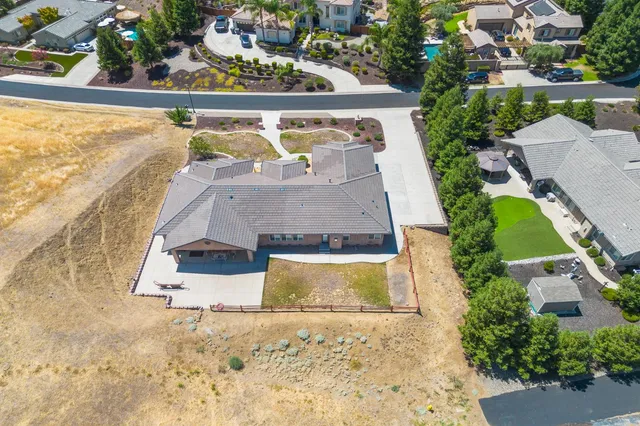 an aerial view of a house with a swimming pool