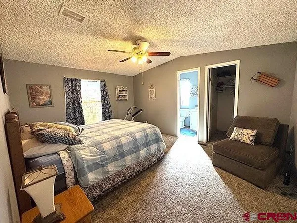 a bathroom with a granite countertop toilet sink and mirror