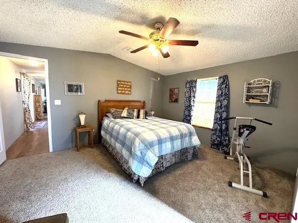 a bedroom with a bed a window and a chandelier