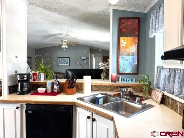 a kitchen with a sink and a refrigerator
