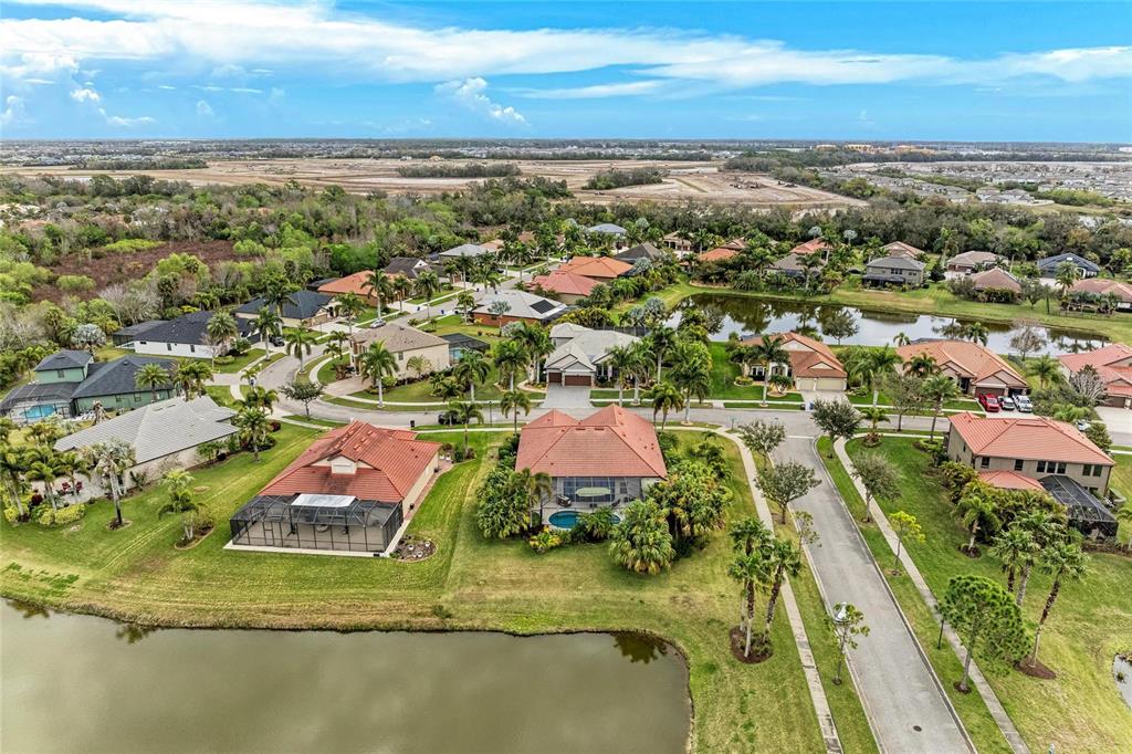 302 Cockle Shell Loop Apollo Beach, FL 33572 - Photo 66 of 75 an aerial view of residential houses with outdoor space and ocean view