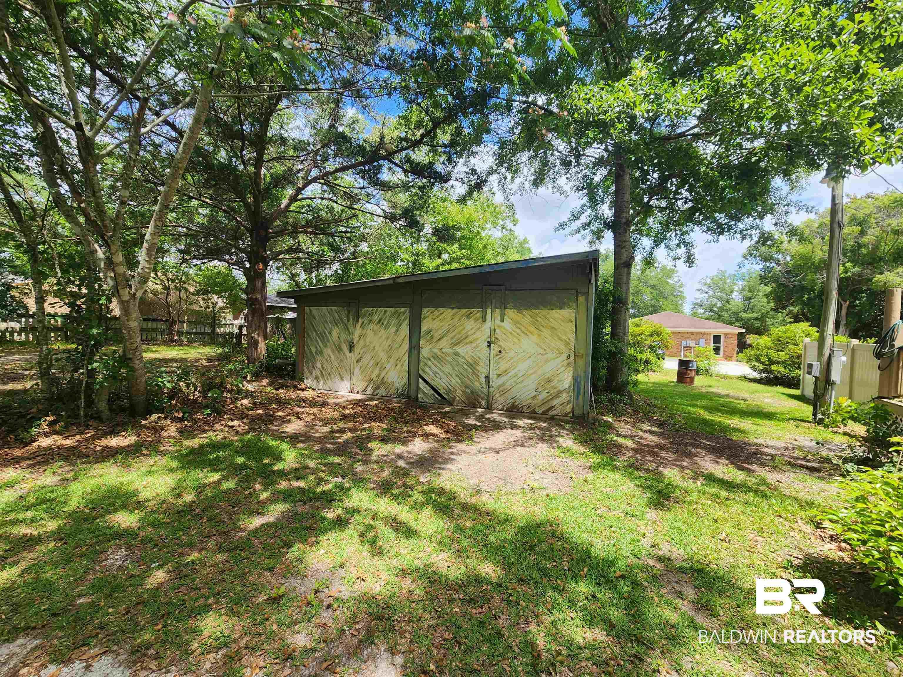 23051 Fritz Lane Foley, AL 36535 - Photo 9 of 26 Exterior storage structure featuring a sloped roof and double panel doors
