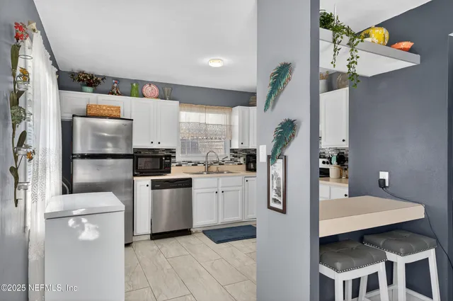 a kitchen with a refrigerator and countertop