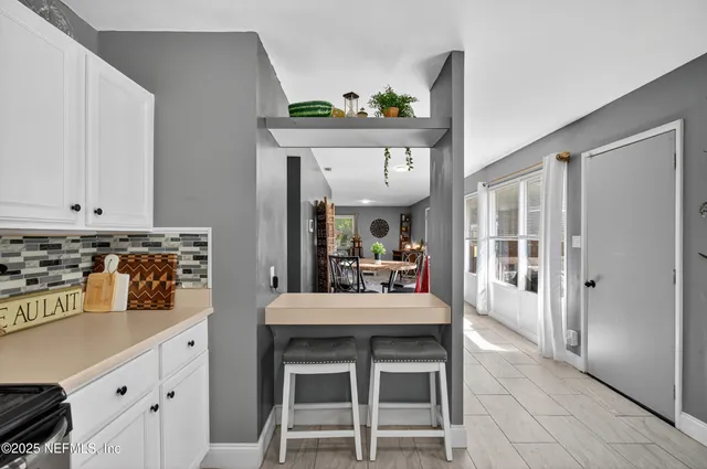 a kitchen with stainless steel appliances kitchen island granite countertop a sink and cabinets