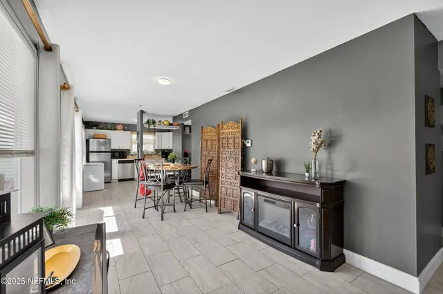 a work room with furniture and view of kitchen