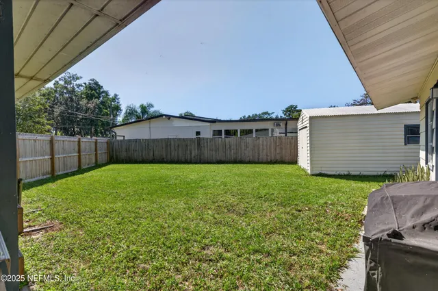 a view of a backyard with a small cabin